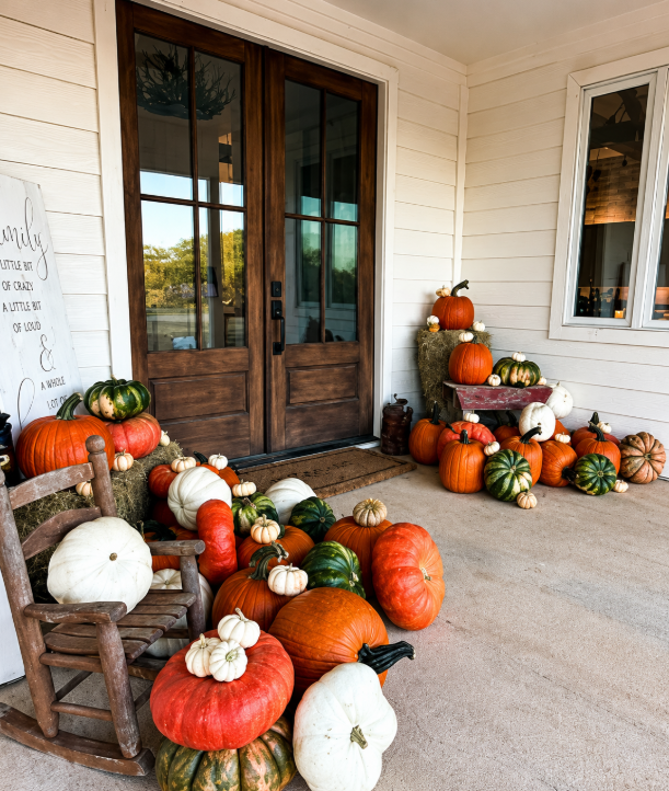 Celebrate Collection pumpkins gathered around a rustic rocking chair