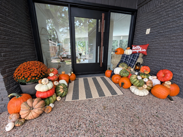 Celebrate Collection fall porch display with pumpkins, mums, and a welcome sign