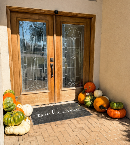 Welcome Collection pumpkins framing wooden double doors