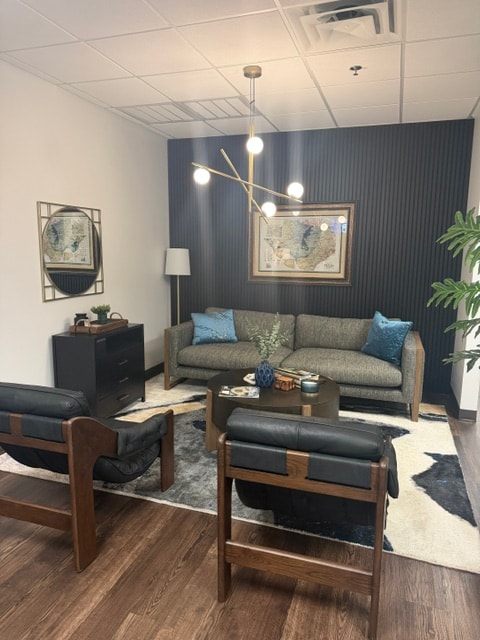 ES3 Office lounge with tailored seating, framed artwork, and a dark accent wall.