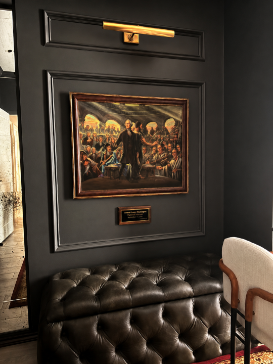 Hewetson Project detail of artwork, brass picture light, and tufted leather seating