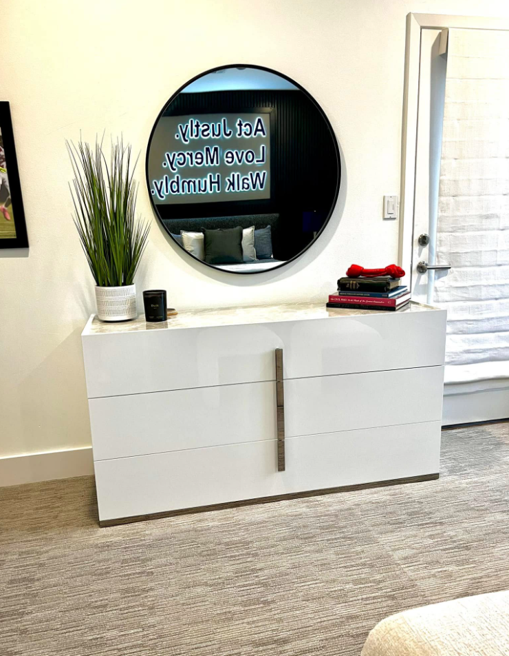 Themed bedroom dresser with round mirror